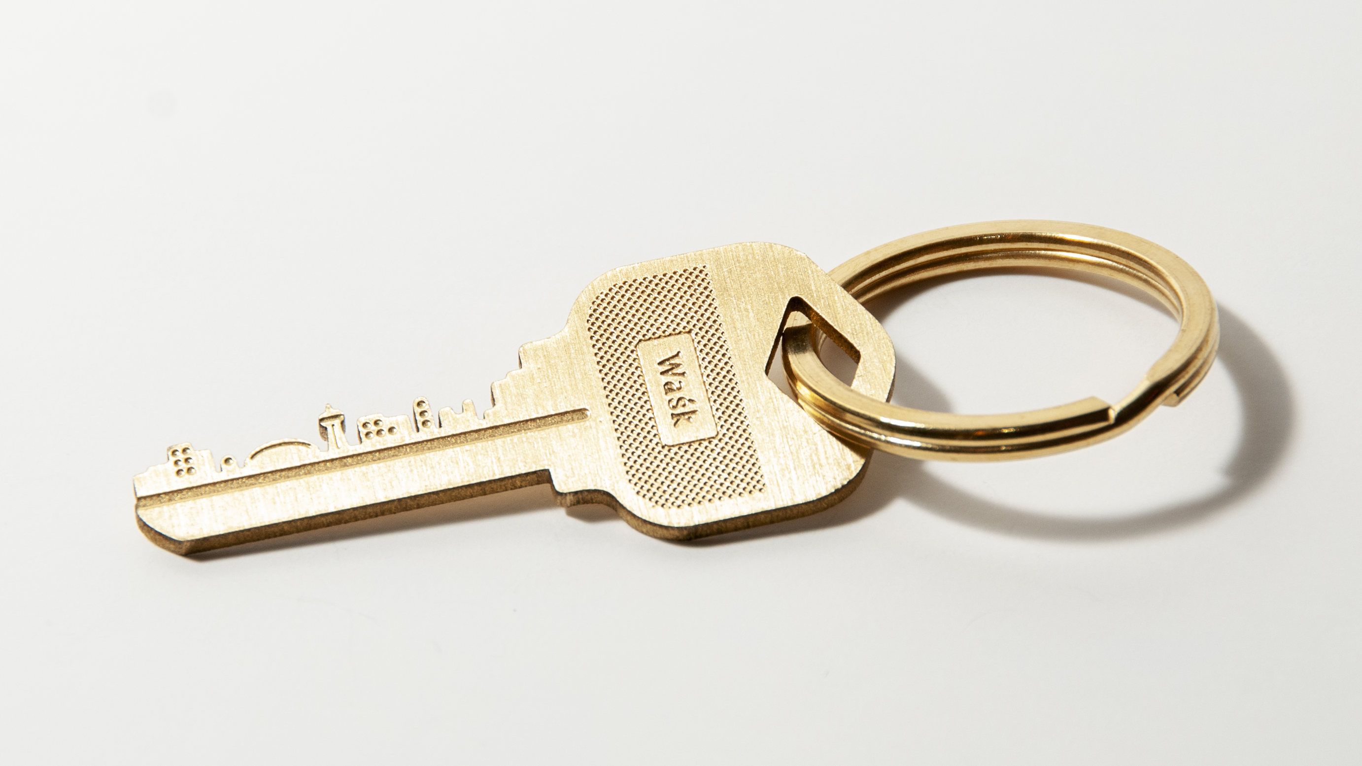 a key keychain with a city on the blade